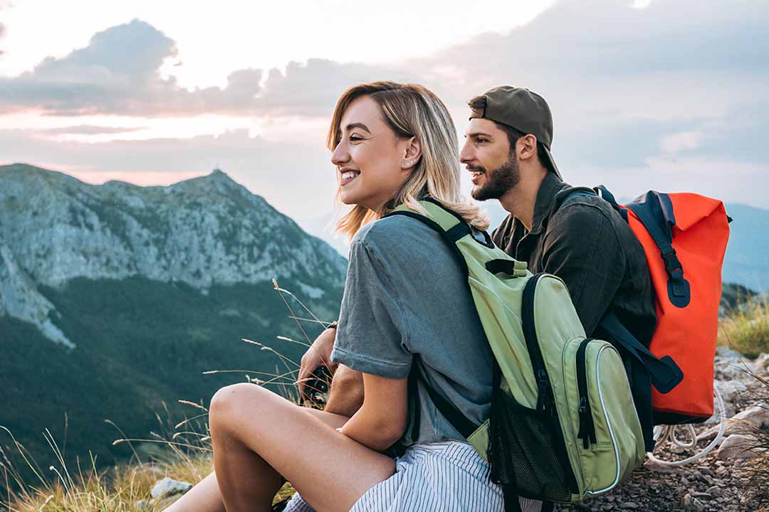 Junges Paar genießt Aussicht auf einem Berg