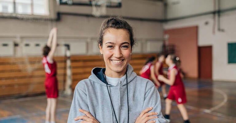 Lächelnde Frau in einer Sporthalle